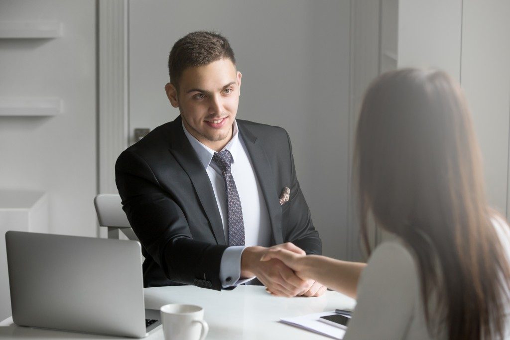 Man shaking hand of applicant