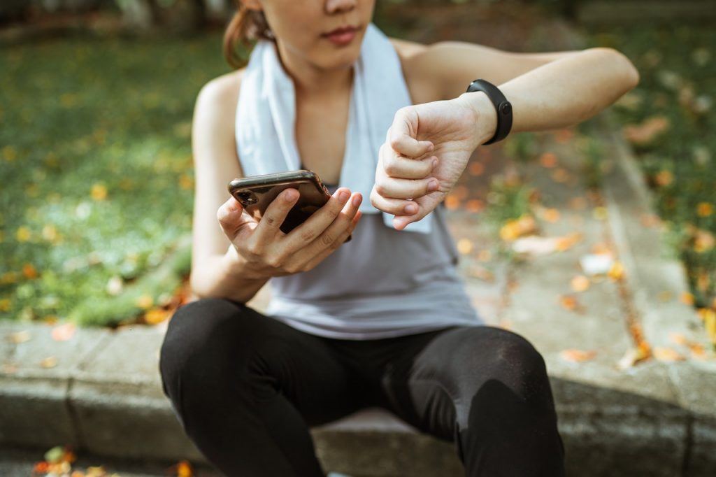 woman checking her smart watch after jogging